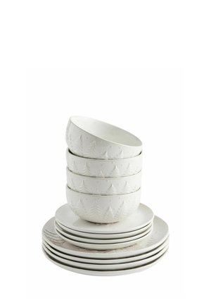 Stack of white ceramic bowls and plates with embossed pine tree patterns on a white background.