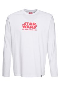 Valkoinen pitkähihaisissa t-paita, jossa on pyöreä kaula-aukko. Paidassa on edessä painettuna punaiset tekstit "STAR WARS" ja "THE EMPIRE STRIKES BACK".