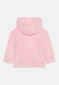 Giacca rosa con cappuccio realizzata in materiale morbido e peloso. Caratterizzata da maniche lunghe e una consistenza soffice, con un cappuccio arrotondato e accogliente e senza chiusure visibili.