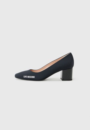 Navy pointed-toe pump with a transparent block heel and "LOVE MOSCHINO" logo on the side, set against a plain white background.