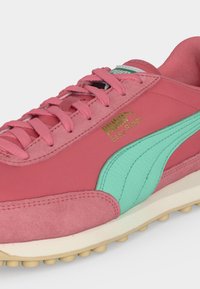 Rózsaszín Puma Easy Rider sneaker türkiz csíkkal, tónusos fűzővel és fehér talppal, bézs tapadást biztosító tüskékkel.