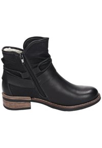 Black leather ankle boot with a textured black upper, side zipper, and brown wooden stacked heel. Features decorative straps.