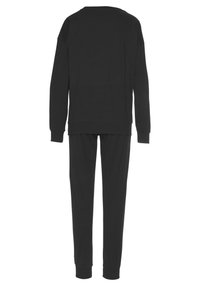 Black cotton sweatshirt and matching pants, featuring long sleeves, a crew neck, and fitted cuffs. Smooth texture, relaxed fit, no patterns.