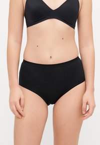 Black high-waisted underwear made of soft cotton with smooth texture and a wide elastic waistband for comfort and support.