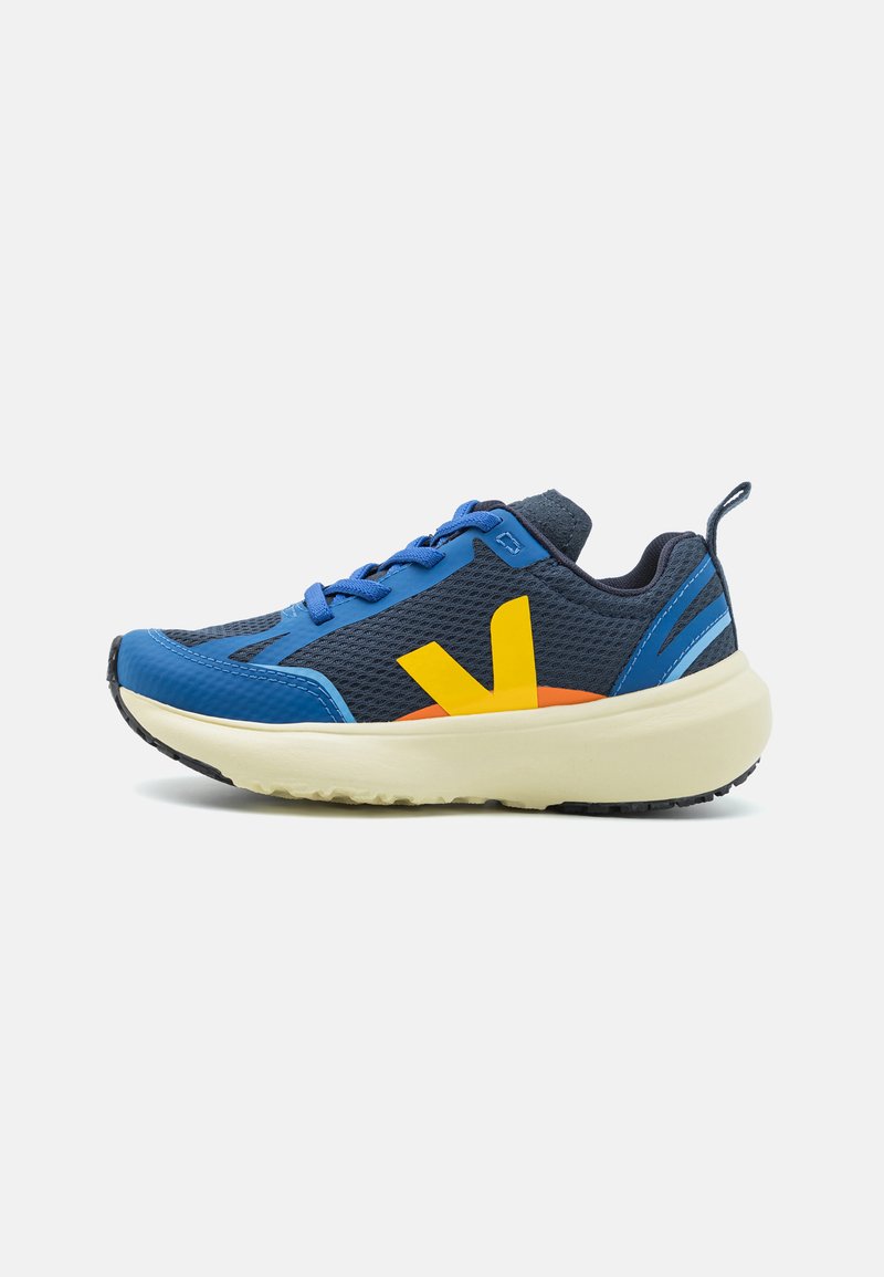 Blue and navy athletic shoe with mesh upper, yellow logo, orange accent, and white rubber sole. Features contrasting laces and heel tab.
