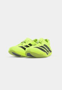 Neon yellow running shoes with black stripes, featuring a lightweight design, lace closure, and textured sole with gray accents.
