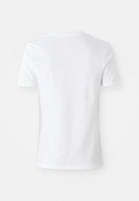 T-shirt blanc à manches courtes, en coton, avec un col rond et une texture lisse. Design simple sans motifs ni éléments visibles.