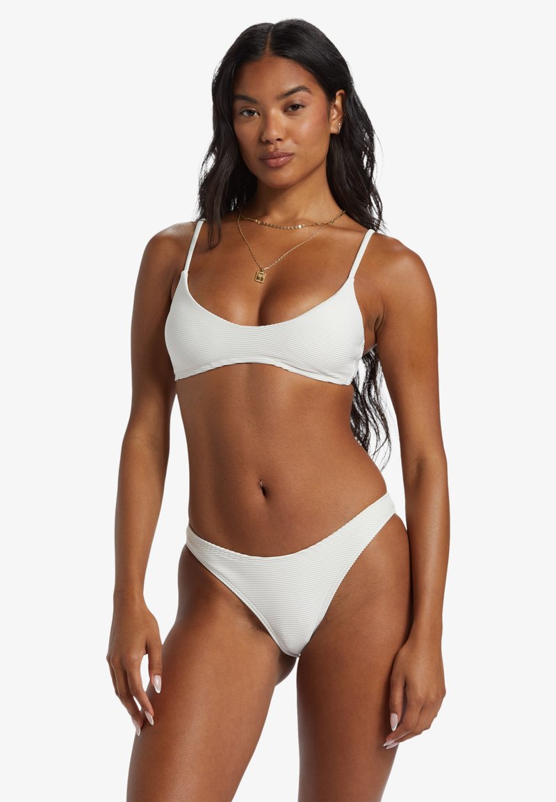 White ribbed bikini set featuring a triangular top with thin straps and matching bottom. Smooth texture, minimal hardware, and simple design.