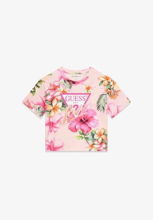 Light pink short-sleeve crop top with tropical floral print and "GUESS U.S.A." logo in pink triangle at center front.