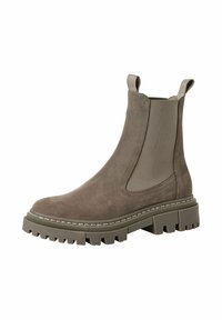 Bottine en daim marron avec des panneaux latéraux élastiques et des languettes de tirage, dotée d'une semelle en caoutchouc épaisse et texturée avec des motifs de crampons prononcés.