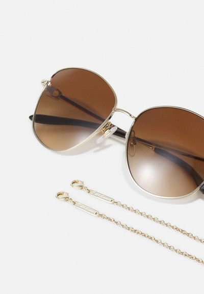 Brown gradient sunglasses with a gold metal frame and black temples. Includes a gold chain with clasps for secure attachment.