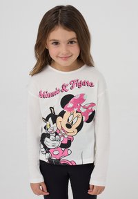 Camicia bianca a maniche lunghe con una grafica colorata di Minnie Mouse e Figaro, decorata con pois rosa e un dettaglio di fiocco con paillettes.