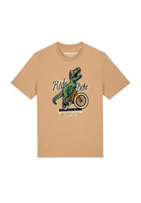 Beige Baumwoll-T-Shirt mit einem grünen Dinosaurier, der ein Fahrrad fährt. Der Text lautet "Fahre ein Fahrrad" und "Die besten Tage." Es hat einen Rundhalsausschnitt und kurze Ärmel.