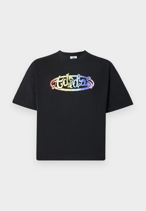 Black cotton t-shirt featuring a multicolored, stylized "Adidas" logo on the front. The design includes curved text and smooth texture.