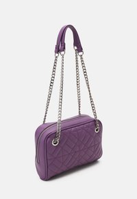 Borsa a tracolla trapuntata viola con una texture in pelle liscia, catene in argento e chiusura a zip. Presenta una forma rettangolare e una finitura liscia.
