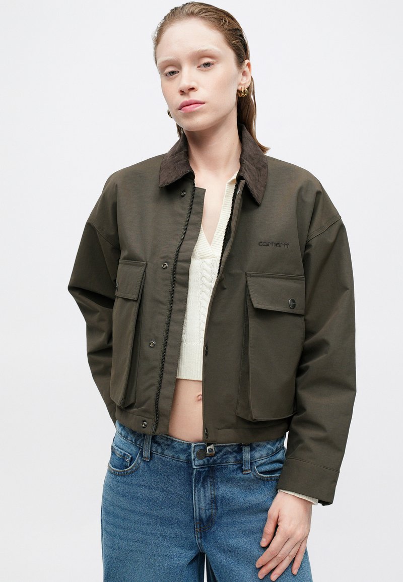 Olivgrüne cropped Jacke mit einem braunen Cordkragen. Verfügt über zwei Vordertaschen, Druckknopfverschlüsse und gestickte Markenkennung auf der Brust.