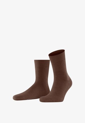 Calze marroni a coste con design a metà polpaccio. Realizzate in materiale morbido con una texture liscia e grip a punti sulla soletta.