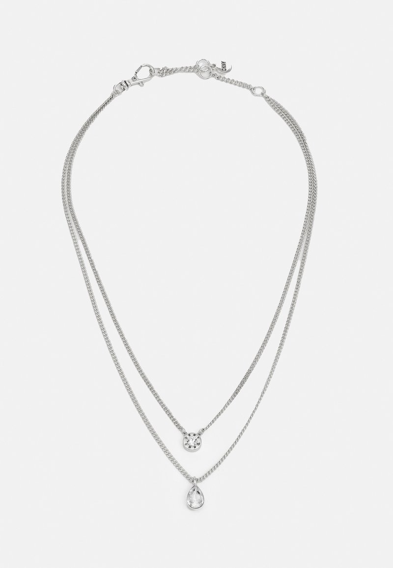 Layered silver necklace featuring two chains; one with a circular pendant and the other with a teardrop-shaped crystal.