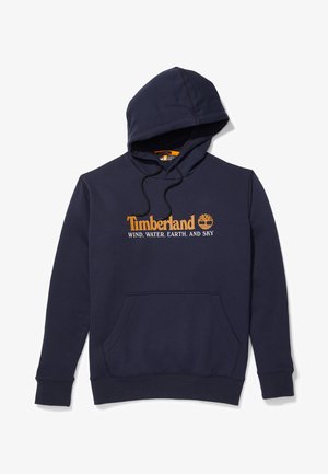 Felpa blu navy in cotone con ampio tascone a marsupio, cappuccio con coulisse e logo Timberland con testo arancione.