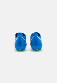 Botas de fútbol azules con una parte superior de malla texturizada, que presentan un diseño elegante, un contrafuerte de talón prominente y tachuelas verdes brillantes en la suela.