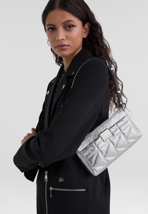 Silver quilted handbag with a rectangular shape, featuring a textured surface, a metal clasp, and a detachable strap.
