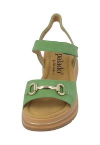 Sandalo verde con fascia larga, parte superiore regolabile e accessori in tonalità oro. Presenta una soletta imbottita e una suola spessa e texturizzata.