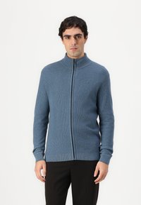 Blue zip-up sweater made of ribbed material with a high collar and long sleeves, featuring a smooth texture and fitted silhouette.