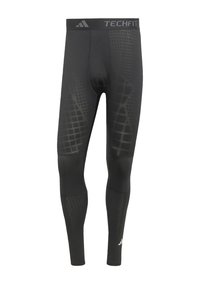 Sorte sports tights med et gittermønster, der har en støttende talje, mærket "TECHFIT", og glat, strækbart stof for komfort.