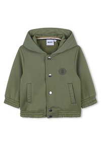 Olijfgroene jack met een capuchon, voorzien van een sluiting aan de voorkant met zilveren drukknoopjes en een logopatch. Inclusief zijzakken en ribgebreide manchetten.