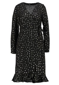 Robe noire enveloppante avec des manches longues, un décolleté en V, des pois métalliques dispersés, une taille à nouer et un ourlet volanté.