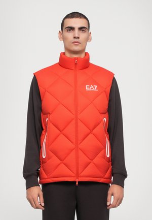Red quilted vest with high collar, zip closure, and white accents. Features side pockets and EA7 logo on the chest.