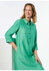 Türkisfarbenes Hemdkleid mit Kragen, 3/4-Ärmeln und lockerer Passform. Hergestellt aus einem strukturierten, leichten Stoff.