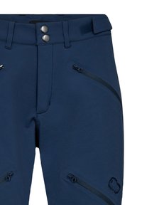 Marineblå bukser med en glat overflade, featuring to lynlåslommer, en trykknap og velcro lukning samt et logo på den nederste del af benet.