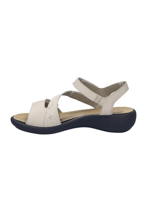 Sandali in pelle beige con cinturini incrociati, soletta imbottita e suola scura. Presentano una texture liscia e cinturini regolabili per adattarsi.