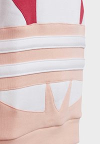 Sweatshirt featuring a color-blocked design with pink, white, and red colors. Soft texture with stitched accents and layered fabric details.