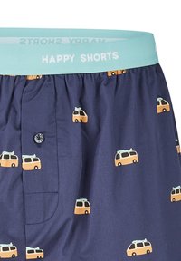 Boxers bleus avec une ceinture bleu clair portant l'inscription "HAPPY SHORTS" et de petits motifs de camping-cars jaunes dispersés sur le tissu.