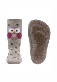 Kindersocken aus grauem Material mit einem Design von rosa und braunen Eulen, grünen Punkten und einer strukturierten braunen Sohle für besseren Halt.