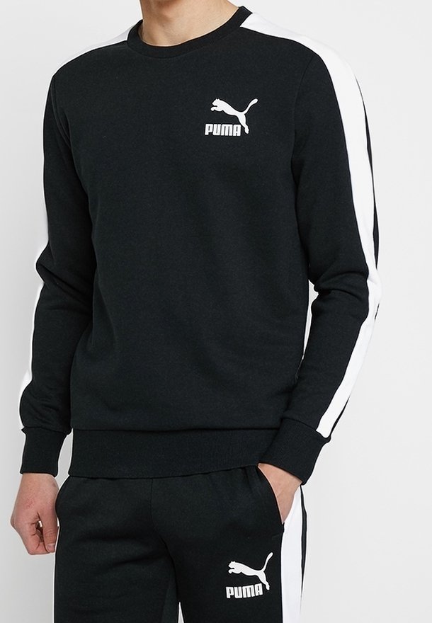 Černá mikina s kulatým výstřihem a bílými bočními pruhy. Na hrudi se nachází bílé logo Puma. Vyrobena z měkké látky.