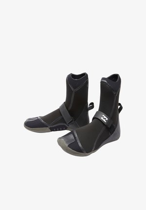 Pair of black neoprene water boots with rubber soles and a securing strap across the top, designed for aquatic activities.