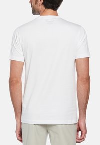 White cotton T-shirt with short sleeves, round neckline, and a soft texture. Features a small logo at the upper back.