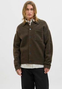 Brown wool cardigan with a collared neck, front buttons, a single chest pocket, and ribbed cuffs; layered over a striped shirt.