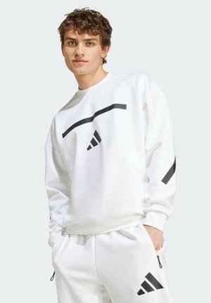 White crew neck sweatshirt with black graphic lines and logo. Fabric is smooth, featuring long sleeves and a relaxed fit.