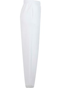 Witte sportieve broek met een elastische tailleband, zijzakken en taps toelopende benen. Gemaakt van zachte stof met een gladde textuur.