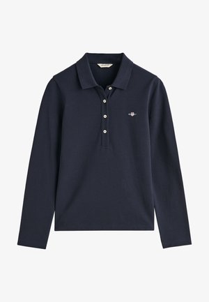 Tume sinine pikkade varrukatega polo-särk, millel on kraega kaelus, kolme nupuga klapp ja brodeeritud logo vasakul rinnal. Kude näeb välja sile.