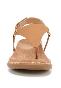 Tan thong sandal with a suede-like material, a flat sole, adjustable strap, and gold hardware accents. Textured footbed for comfort.