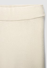 Cremfarbener Strickstoff mit einem gerippten Bündchen und glatter Textur, geeignet für Pullover oder Hosen. Einheitliche Oberfläche mit subtiler Weichheit.