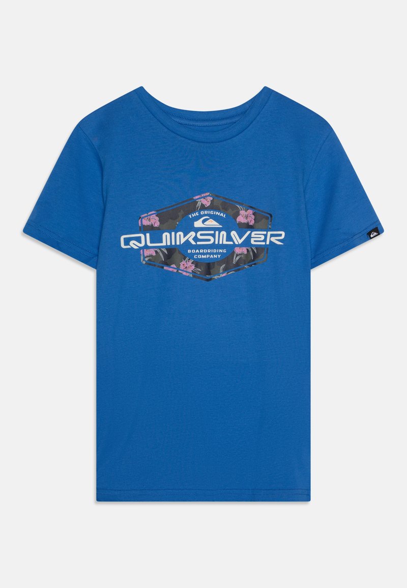 T-shirt de algodão azul com um logo hexagonal da Quiksilver adornado com detalhes florais. Mangas curtas, decote redondo e textura suave.