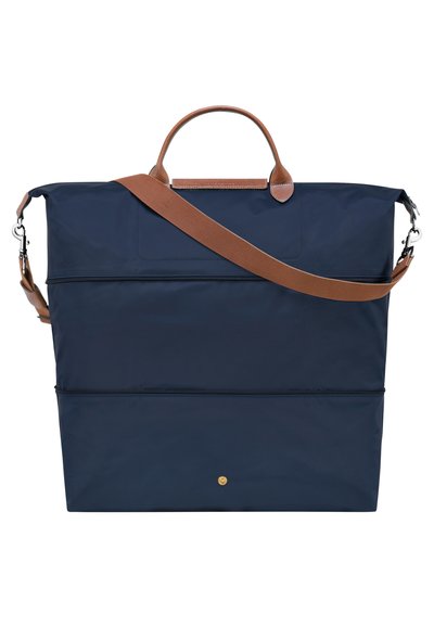 Navy blue tote bag with a structured shape, leather accents, top handle, and adjustable shoulder strap. Features two zippered compartments.