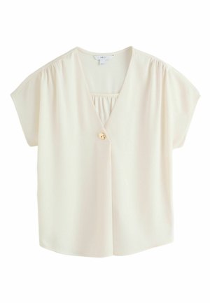 Blusa crema a maniche corte con scollo a V, chiusura con un solo bottone dorato e leggere arricciature sulle spalle e sulla scollatura.