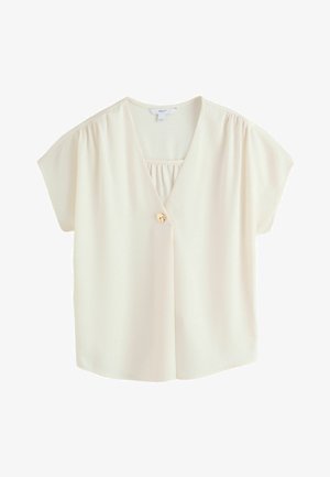 Kortærmet bluse i cremefarve med V-hals, enkelt guldknaplukning og let rynkning ved skuldre og halsudskæring.